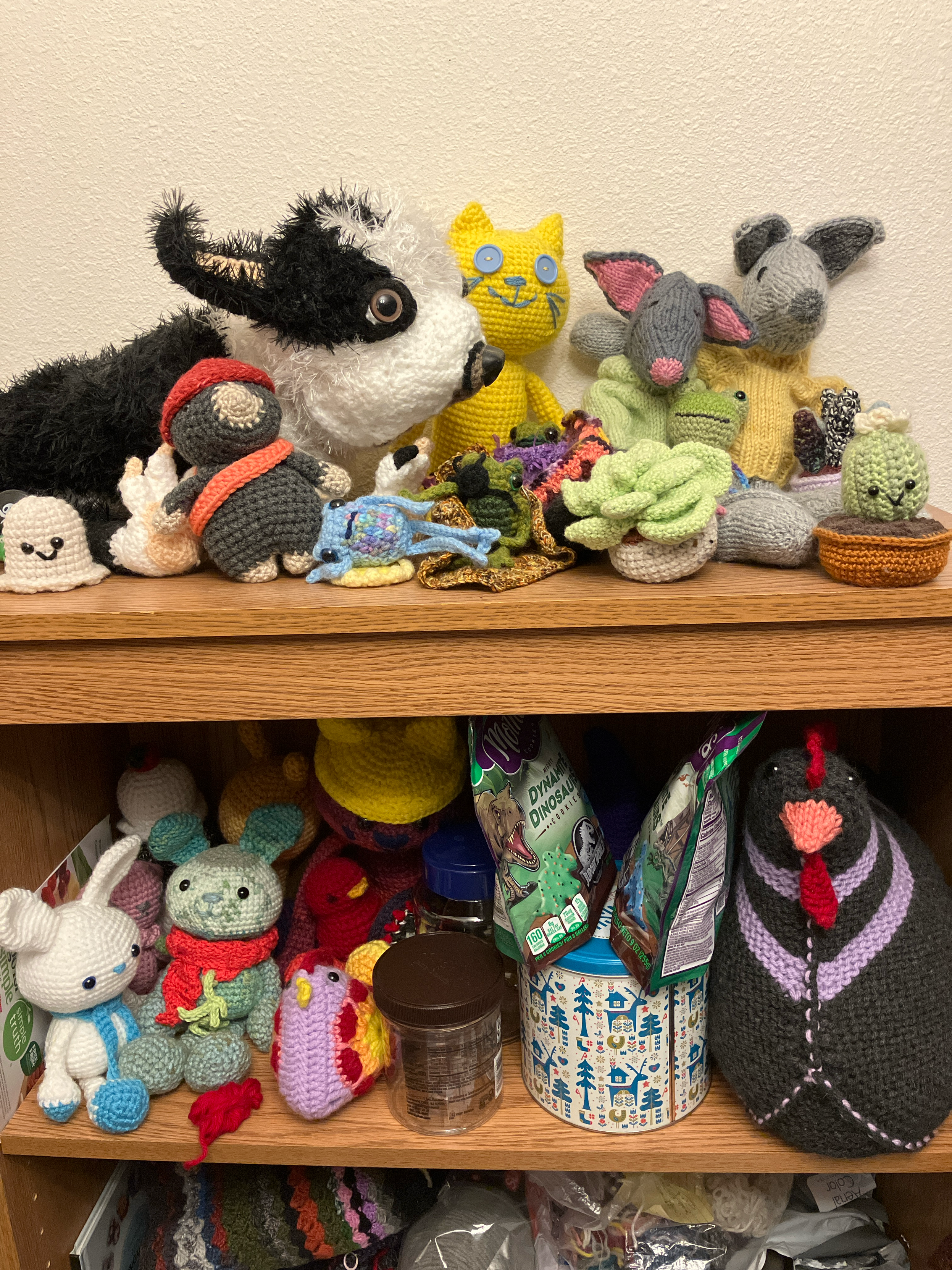 Two shelves of crocheted creatures.
