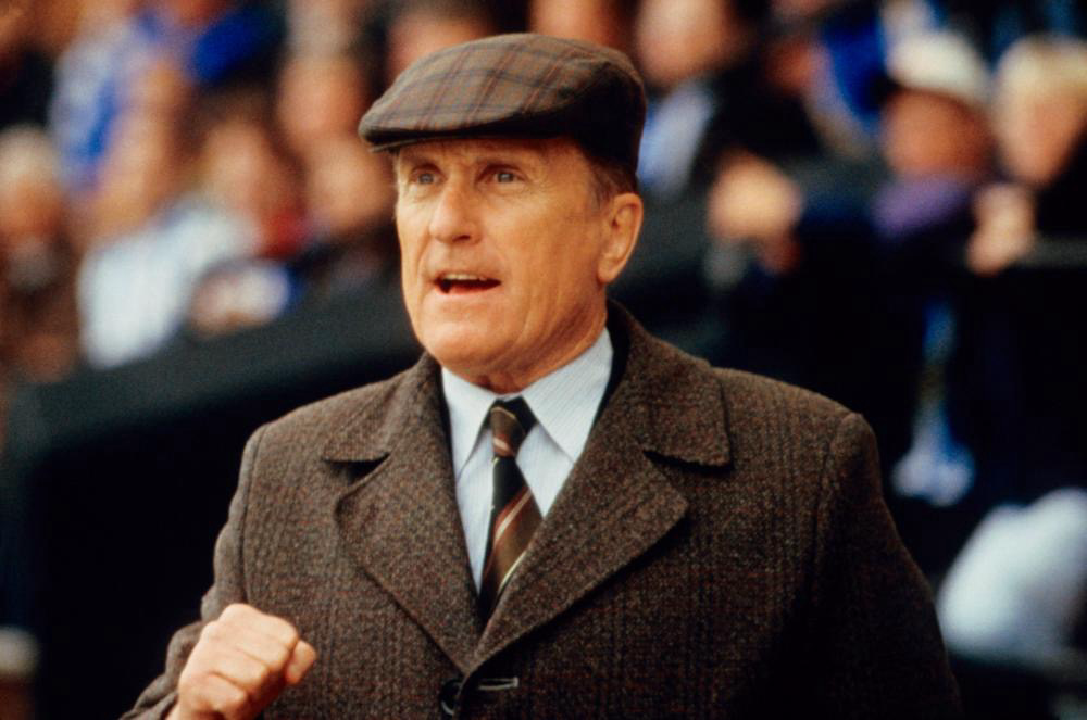Robert Duvall wearing his brown plaid flat hat.
